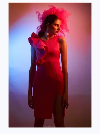Another angle from the "Badass Barbie" shoot. This image showcases the dramatic silhouette of the pink ruffle dress and tulle headpiece under creative, multi-colored lighting.