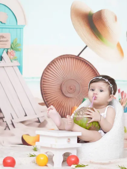 Enjoying a refreshing drink of coconut water. Our beach setup includes real sand and fun props to create an authentic seaside vibe.