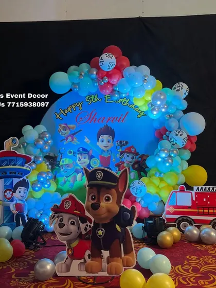 This Paw Patrol themed birthday setup is perfect for little adventurers. It features a custom backdrop with the whole pup squad, character cutouts of Chase and Marshall, and a colorful balloon arrangement.