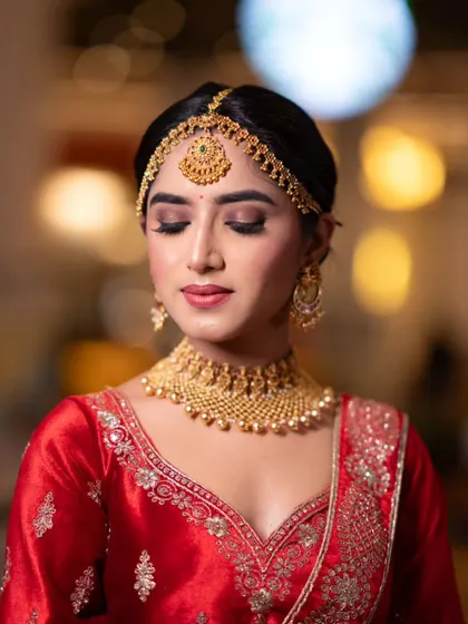 A close-up with eyes closed, showing the perfectly blended neutral eyeshadow and sharp eyeliner.