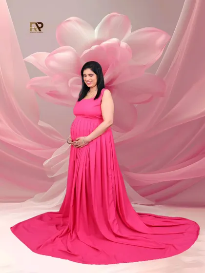 A vision in pink. This solo portrait showcases a beautiful pink gown against a matching pink floral backdrop, creating a soft, dreamy, and monochromatic look.