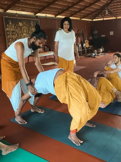 Assisting a student in Urdhva Dhanurasana (Upward Bow Pose) is about creating a safe opening for the heart. We teach how to support the student's body so they can experience the full expression of the pose without strain.