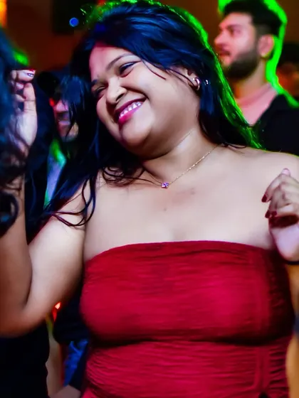 A radiant smile from a dancer feeling the energy of the music.