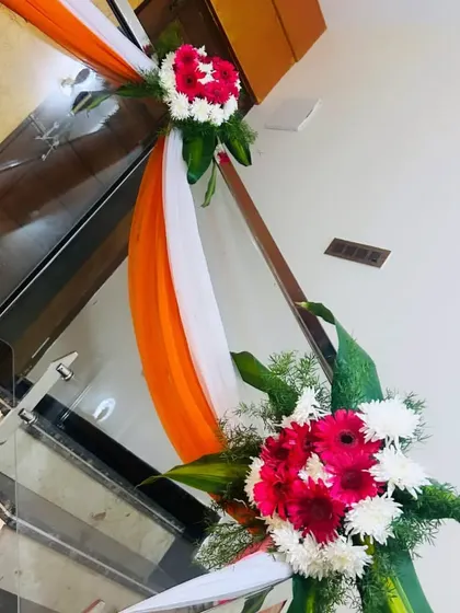 Railing decor using tricolor drapes (orange, white, and green) for a national holiday or themed event.