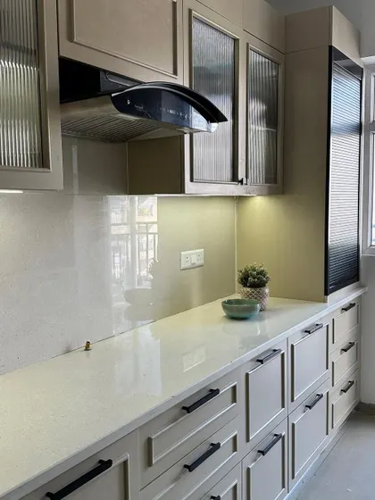 A close-up of the kitchen countertop, showing the under-cabinet lighting that provides excellent task lighting and highlights the clean finish of the cabinetry.