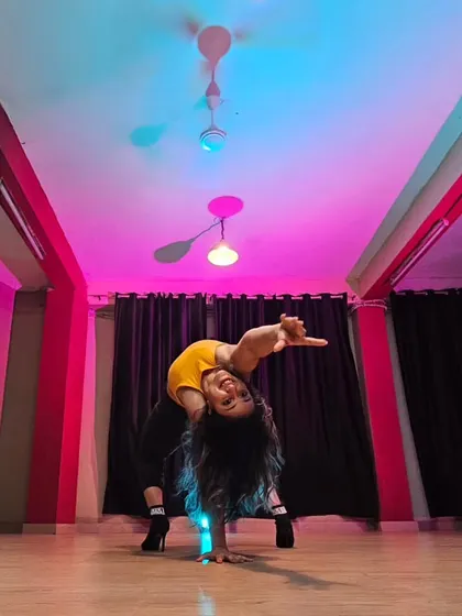 A dynamic pose from a heels dance session, showing the blend of strength, flexibility, and artistry we cultivate. This is what it feels like to be fully in your power and connected to your movement.