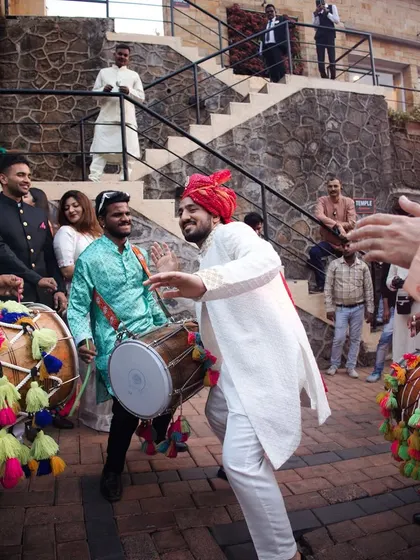 The infectious energy of the dhol players gets everyone dancing at the baraat. The rhythmic beats are the heart and soul of a Punjabi wedding procession.