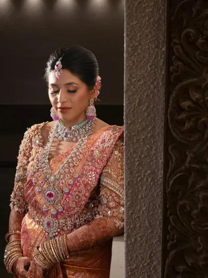 A close-up of the bride's beautiful smile and her stunning ensemble. The intricate details of her blouse are simply breathtaking.