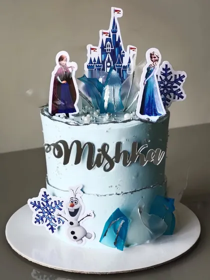 Let it go with this Frozen-themed birthday cake. The icy blue buttercream is adorned with snowflakes, an ice castle, and characters like Elsa, Anna, and Olaf, with sugar crystals for a frosty finish.