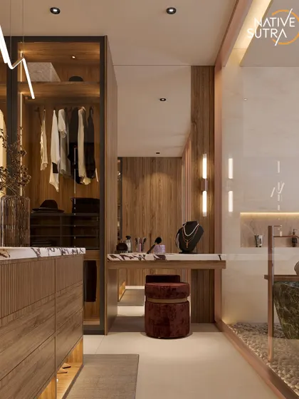 The Zen Luxe dressing area offers a peek into the bathroom, with its green marble tub visible. The space features a walk-in closet and a dedicated vanity with warm wood and marble details for an inviting, sophisticated touch.