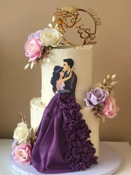 Another view of the two-tiered engagement cake with the custom couple illustration and purple dress.