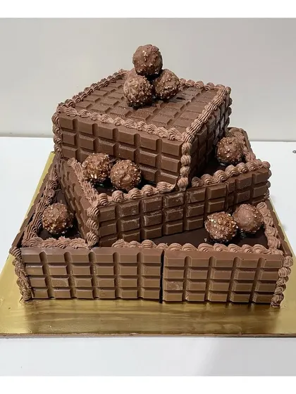This angle shows the cascading structure of the three-tier Ferrero Rocher and Cadbury chocolate cake.