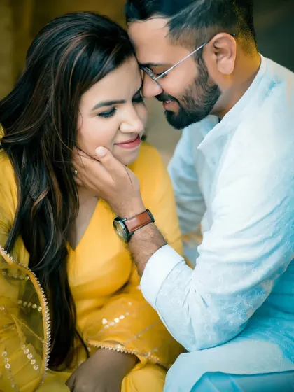 A close-up shot that highlights the couple's connection. The groom gently holds the bride's face, creating a romantic and tender pre-wedding photograph.