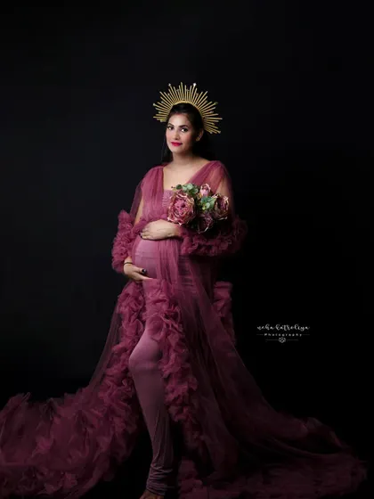 Holding a bouquet of matching flowers, this portrait combines the regal feel of the sunburst crown with the soft texture of the gown.