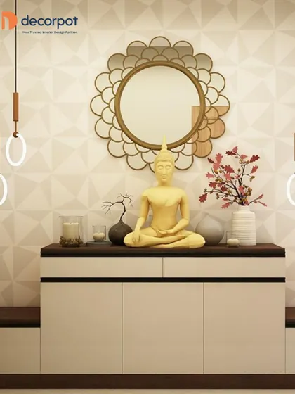 This foyer features a white console table decorated with a Buddha statue and a unique floral-patterned mirror. The hanging pendant lights on either side add symmetry and style.