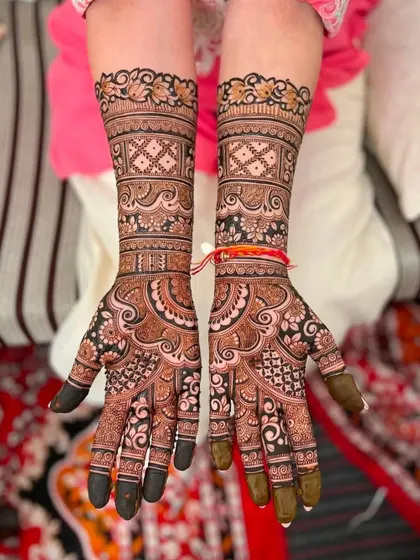 A beautiful and clean bridal design with repeating floral and geometric bands. The symmetry between both hands is perfect.