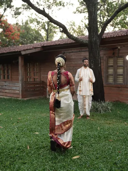 A lovely shot showcasing the traditional bridal hairstyle, complete with a beautiful braid and fresh flowers, which is an essential part of the South Indian muhurtham look.