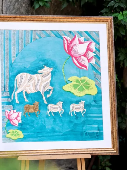 A framed piece from my modern Pichwai series, displayed on an easel. This artwork reinterprets the stories of Lord Krishna and the decorative backdrops of Shrinathji temples from my native Rajasthan.