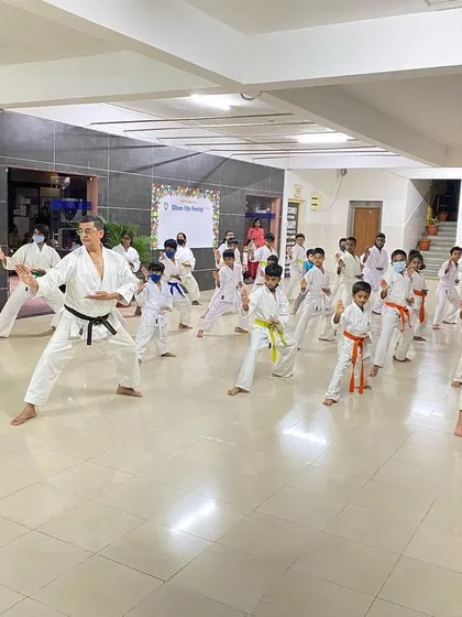 A Sensei leads the class in Kihon practice at the Silicon City dojo, demonstrating the correct form and ensuring every student develops a strong technical base.