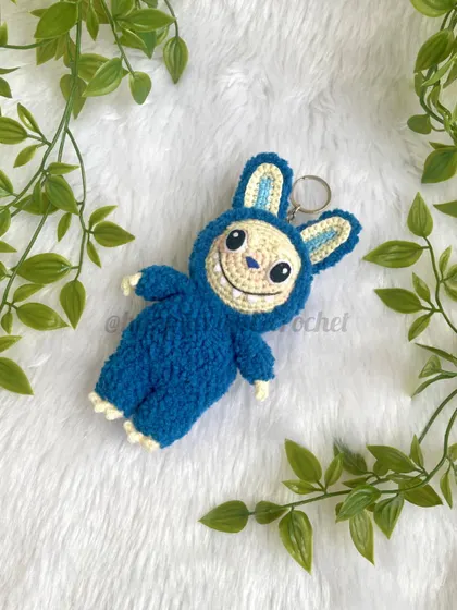 The trendy monster Labubu as a fluffy keychain. His unique look and soft texture make him a fun and eye-catching accessory.