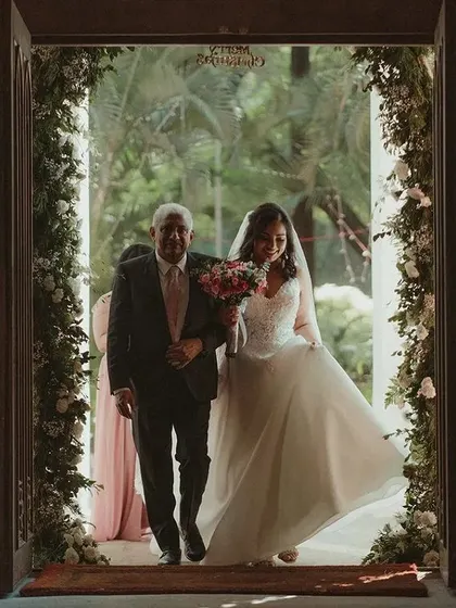 A bride's entry can feel like stepping from one world into another. This moment captures Soumya walking down the aisle with her father, a beautiful and emotional start to her church wedding ceremony.