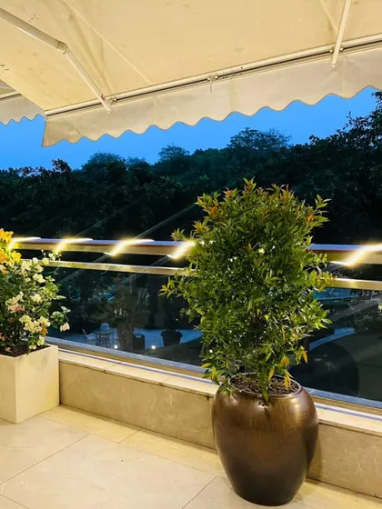 Another view of the DLF Camellias project, showing how we balance different plant textures and pot styles. The warm fairy lights add a magical touch to the evenings, making it a perfect spot to unwind.