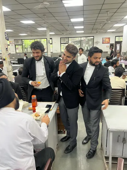 Seeking blessings from a senior member in the bar library. Respect for elders is paramount.