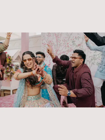 Pure energy and fun on the dance floor. This candid shot captures the couple letting loose and enjoying their celebration with friends, showcasing the joyful and high-energy moments of the day.