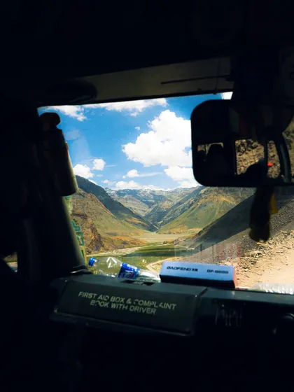 A framed view of the Spiti Valley landscape from inside a vehicle. Using frames within a frame is a creative technique I use to add depth to my shots.