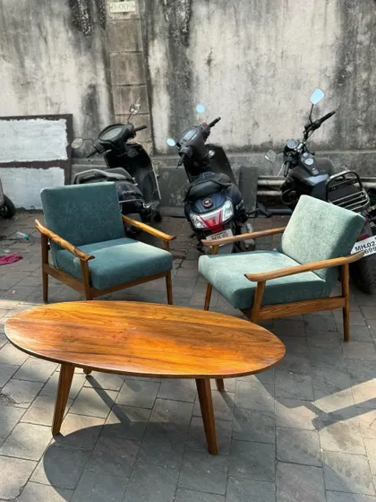 The lounge chairs paired with a matching oval coffee table to form a complete seating group.