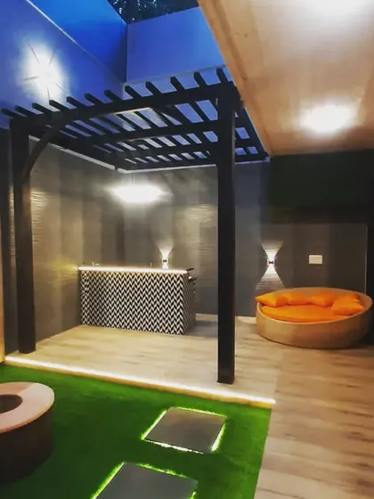 The bar and lounge area at night. The dark walls and warm lighting create an intimate and moody atmosphere.