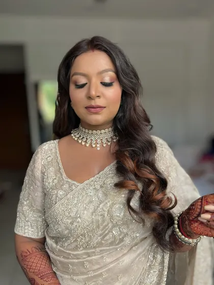 A close-up with eyes closed, showing the shimmery, neutral eyeshadow.