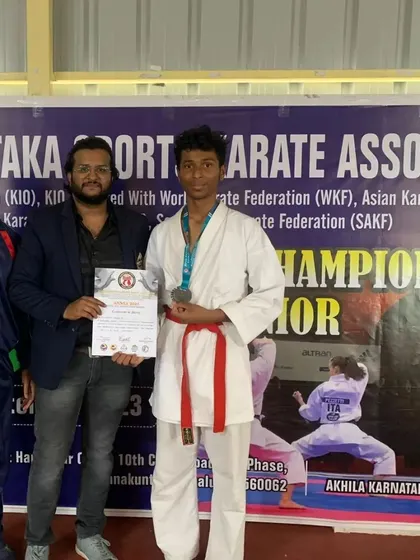 Another shot of Neeraj receiving his certificate and medal at the state championship.