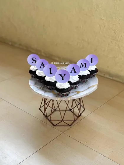 Cupcakes that spell out the name "SAIYAMI" in a lovely purple theme. We can teach you how to make custom toppers for any occasion.