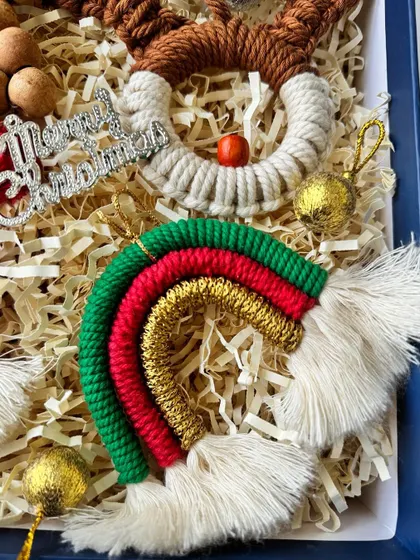 The Christmas-themed rainbow ornament, featuring red, green, and gold, is a festive twist on my classic design.