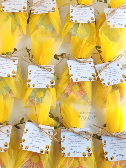 The beautifully packaged daisy wax sachets, wrapped in yellow net with custom "bee-themed" thank you cards.