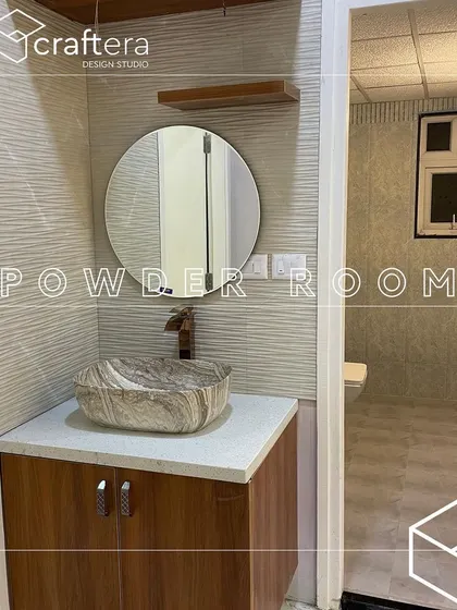 A compact and elegant powder room. I used a stylish marble-finish countertop basin, a round mirror, and textured wall tiles to create a luxurious feel even in a small space.