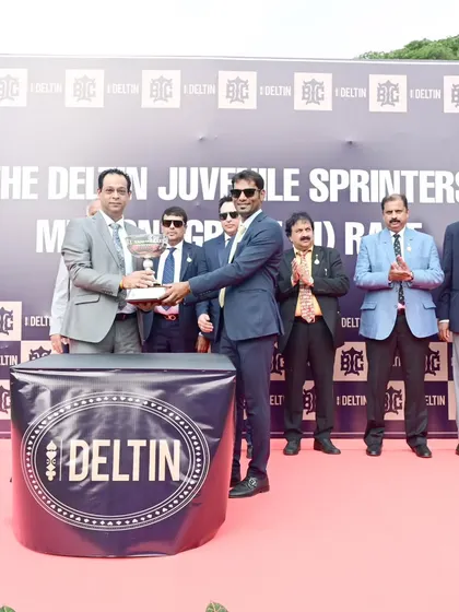 Mr. Khushru Randelia of Deltin presents the trophy for The Deltin Juvenile Sprinters' Million to the owner of Indian Brocade.