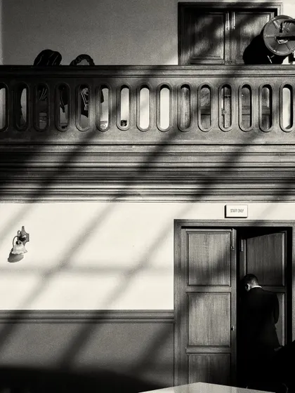 Shadows from the windows fall across the wall and floor, creating graphic patterns that change throughout the day.