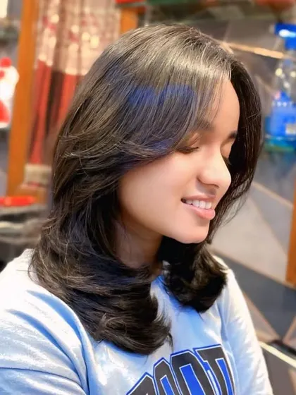 This is the result of a perfect layered haircut with feathered ends. The style adds incredible volume and movement, and the blowout styling makes the layers stand out beautifully.