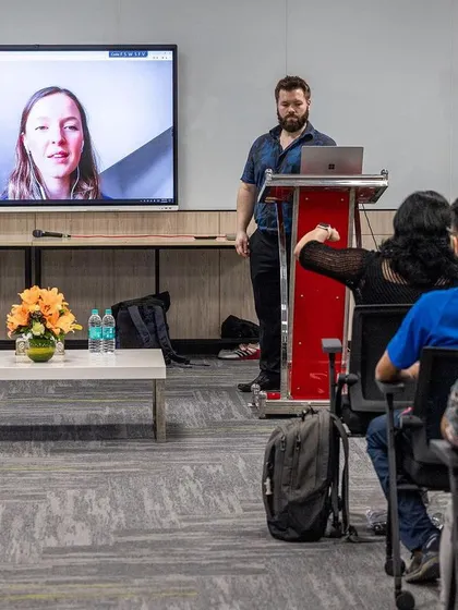 An international expert presents remotely, discussing her research with the audience at the 2024 UKSCA conference.