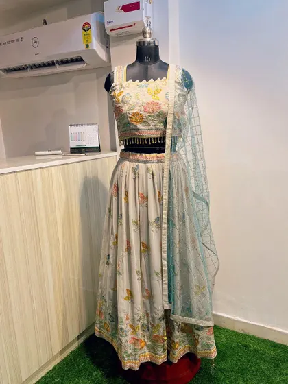 The complete look of the lightweight grey lehenga with leaf embroidery. It comes with a contrasting light blue net dupatta for a soft pop of color.