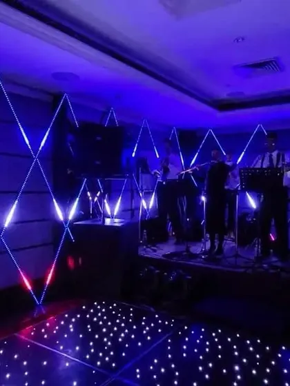 A dazzling dance floor with an LED-lit stage, perfect for a high-energy Sangeet or cocktail party.