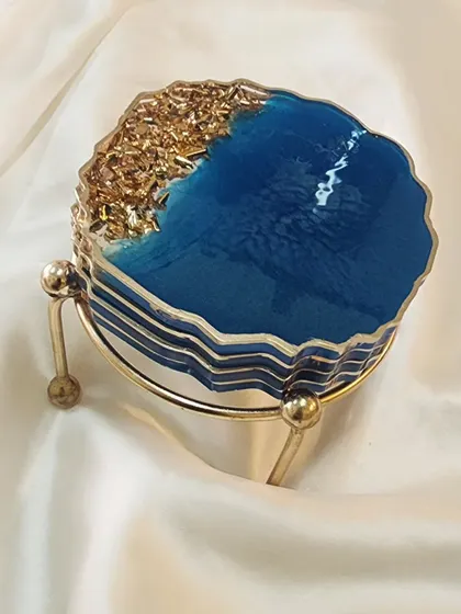 Another view of the blue and gold coaster set, stacked and ready to go with its metal stand.