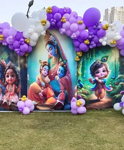 Another shot of the Krishna-themed decor, showing the details of the balloon arrangement and the custom printed backdrop.