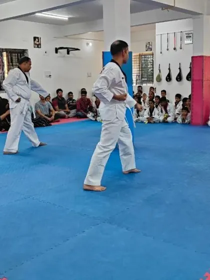 Two senior students demonstrate a form.