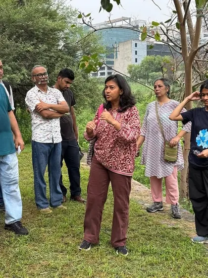 Our volunteer Charu Govil leads a community walk at Ghata Bundh, guiding visitors through the restored 17-acre site and sharing stories of its transformation.