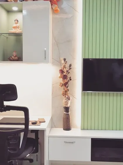 This custom unit combines a work-from-home study desk with a TV wall unit. The design uses a mix of white and pastel green panels, with overhead cabinets for extra storage.