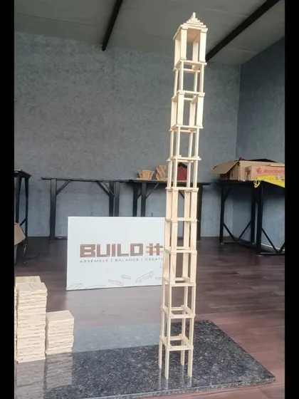 How high can you go? This tall, slender tower tests the limits of stability and balance. It is a classic challenge that encourages teams to think vertically and manage risk with every block they add.