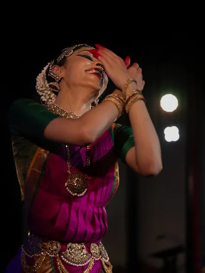 A moment of pure joy and connection with the divine, captured during the Kalāmārga festival. The hands are held in a gesture of offering and receiving grace.